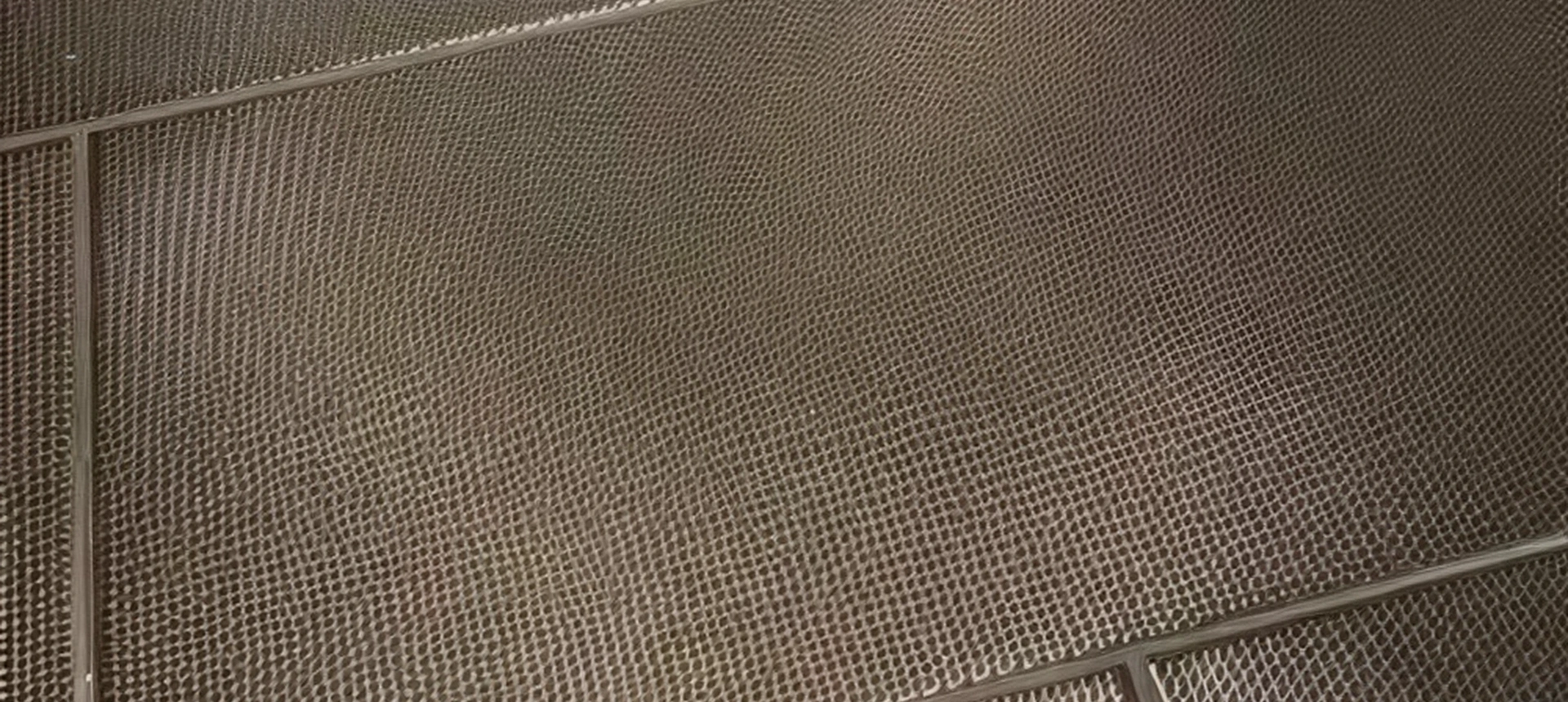 Brown textured metal grate floor surface.