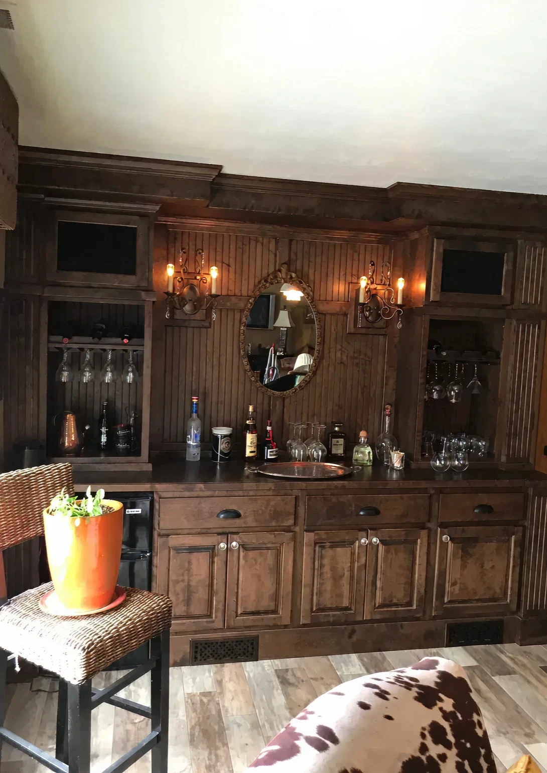 Rustic home bar with wooden cabinetry.